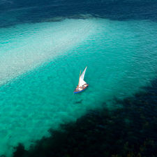 A sailing boat in the clear waters of the Glenan Archipelago.