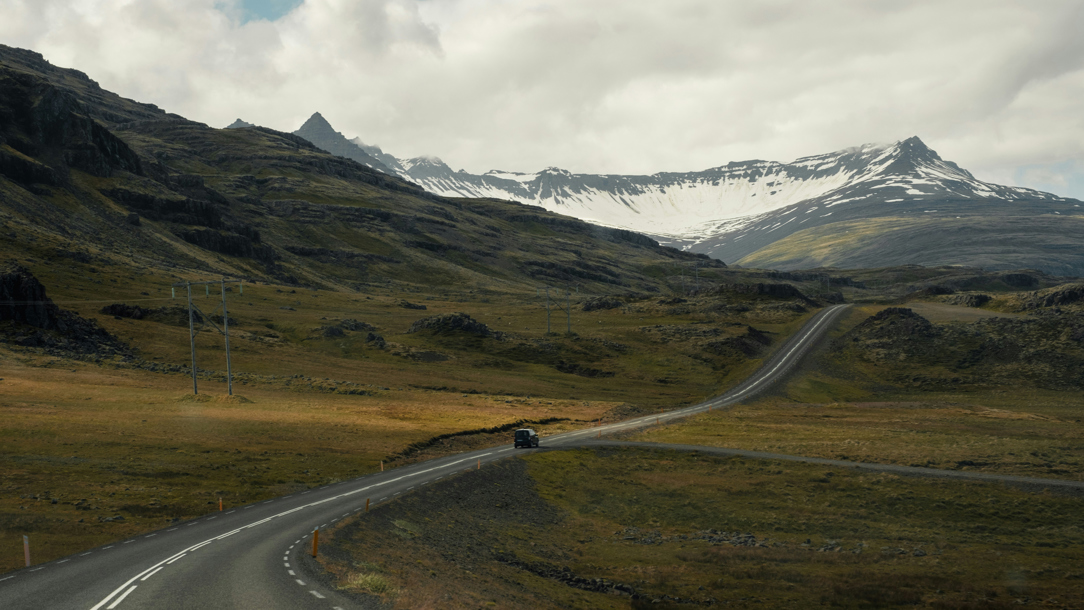 A car driving in a remote landscape in Iceland