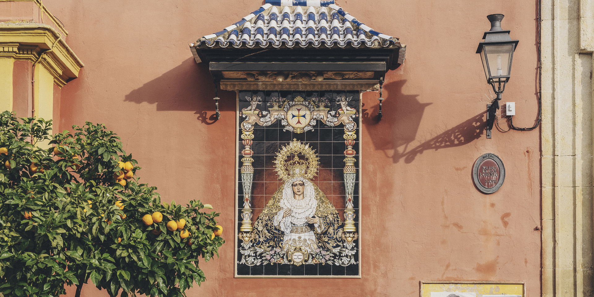 A votive sculpture on a street wall in Sevilla.