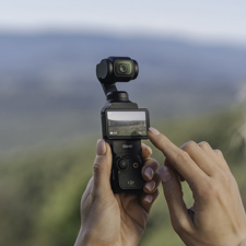 A woman using the DJI Osmo Pocket 3 camera.