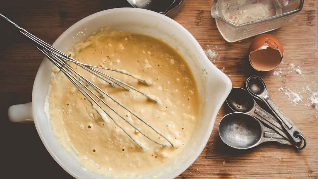 A whisk in batter.