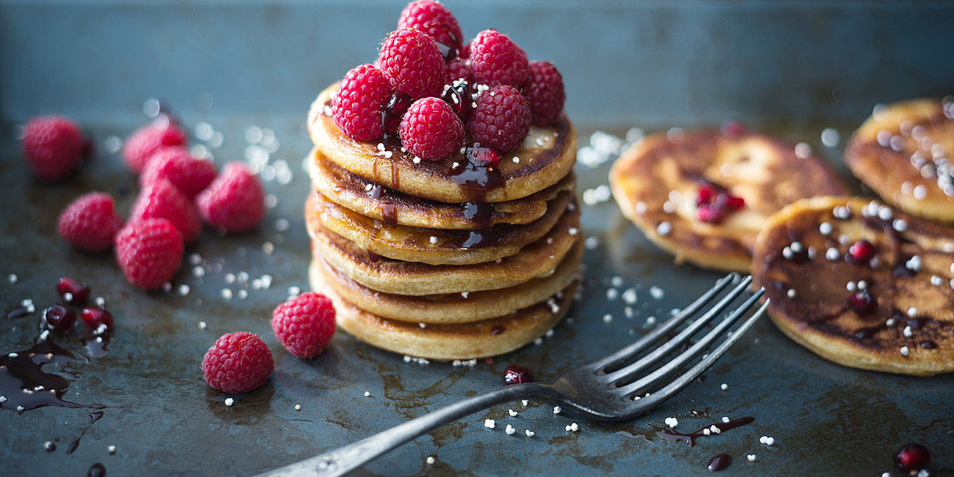 A stack of pancakes with fruit on top.