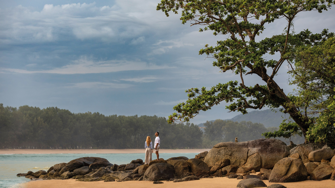 A couple on the beach at the Anantara Layan resort.