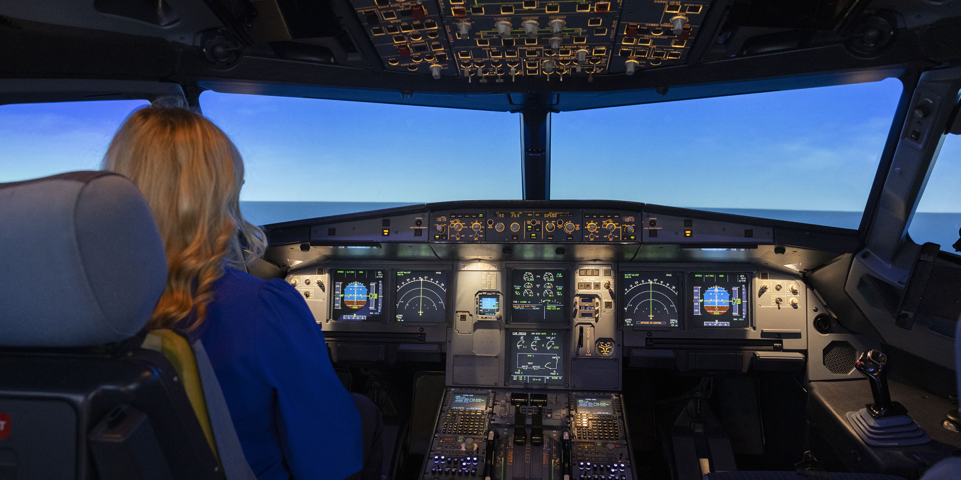 A woman in a flight simulator at the British Airways Global Learning Academy.