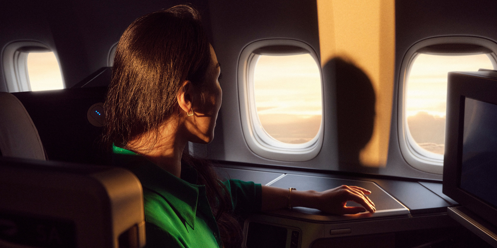 A woman gazing out of the window in her Club Suite.