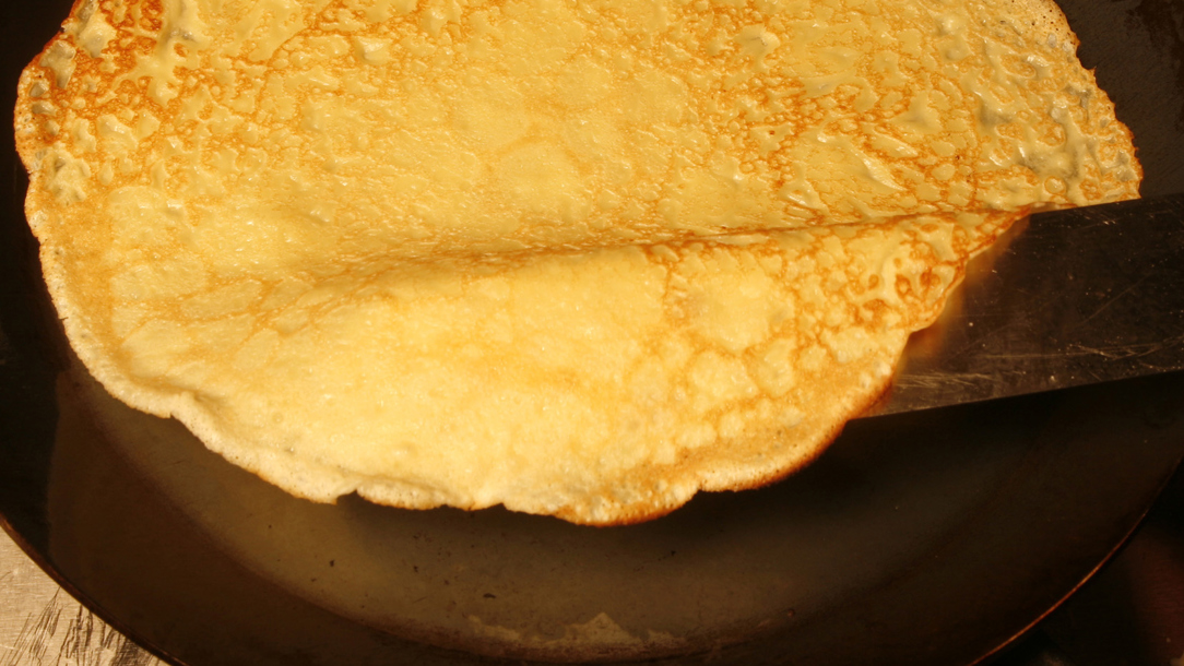 A pancake being cooked.