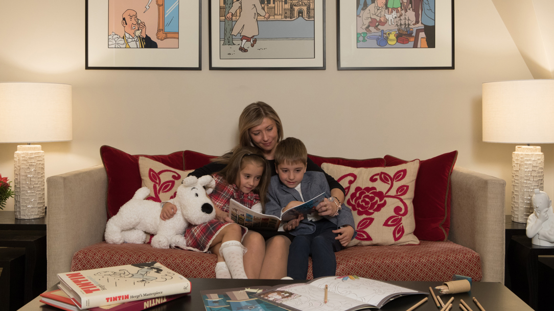 Two children being read a story at the Hotel Amigo.