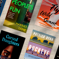 A collection of new books on a linen background.