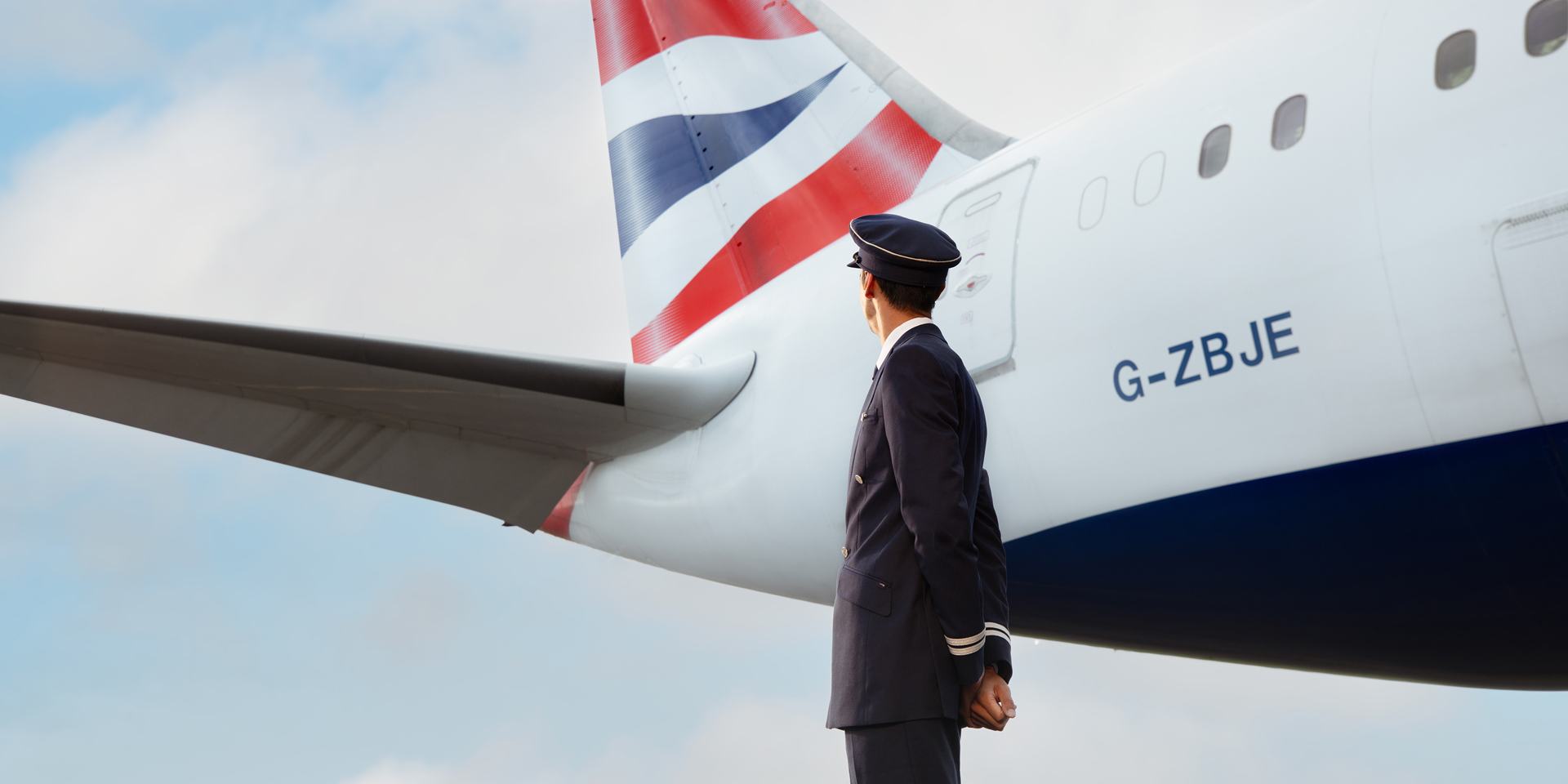 A British Airways pilot looking at his 787 plane.