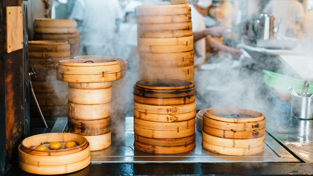 Dim sum baskets on display in a kitchen.