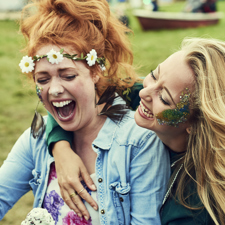 Two women eating ice cream at a music festival.