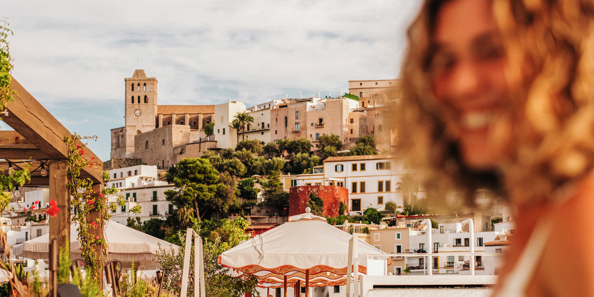 A woman smiling on holiday in Ibiza.
