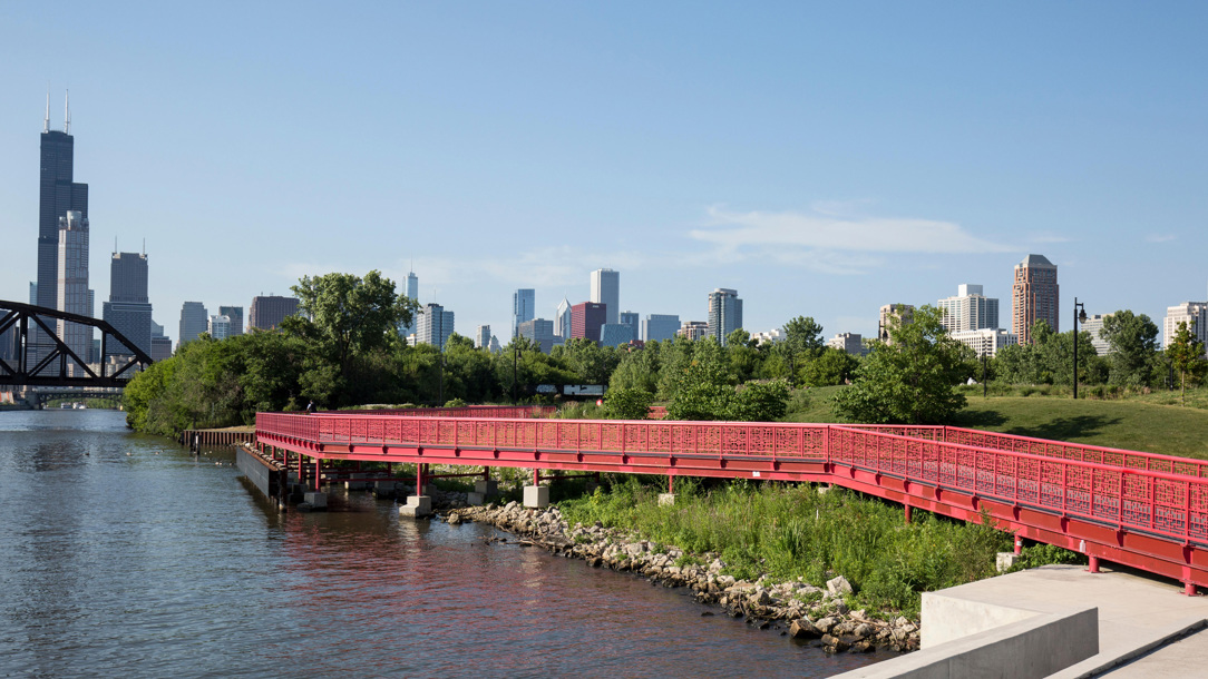 A red bridge across water.