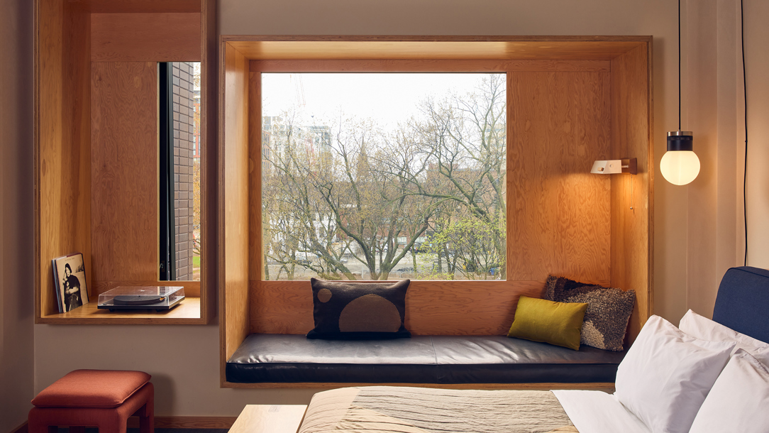 A room at the ACE Hotel in Toronto with a view of trees.