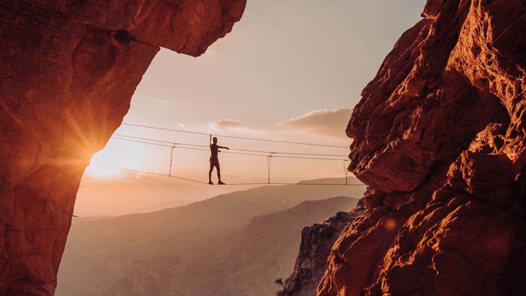 An aerial walkway at sunset.