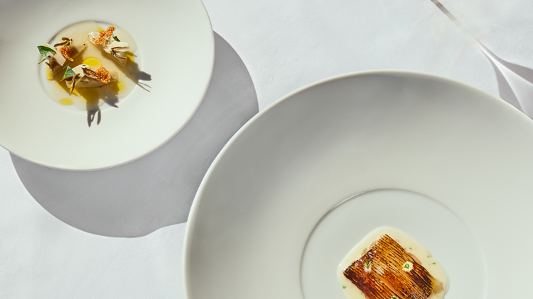 A squid dish from Brooklands with a small model of a plane next to it.