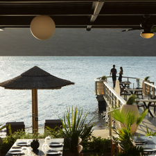 A couple of a walkway outside a restaurant at the Domes of Elounda.