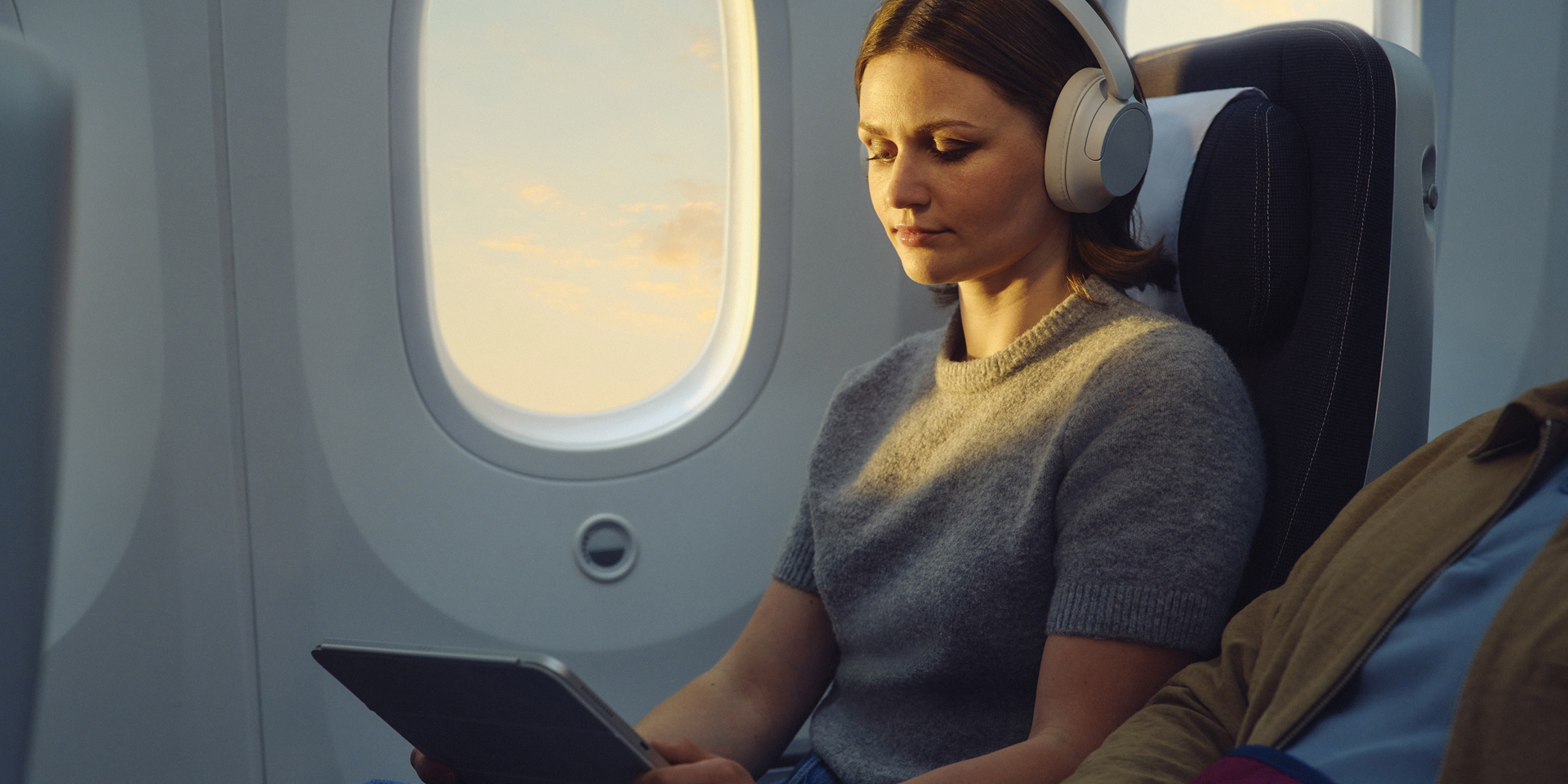 A lady enjoying the inflight entertainment on a British Airways plane.