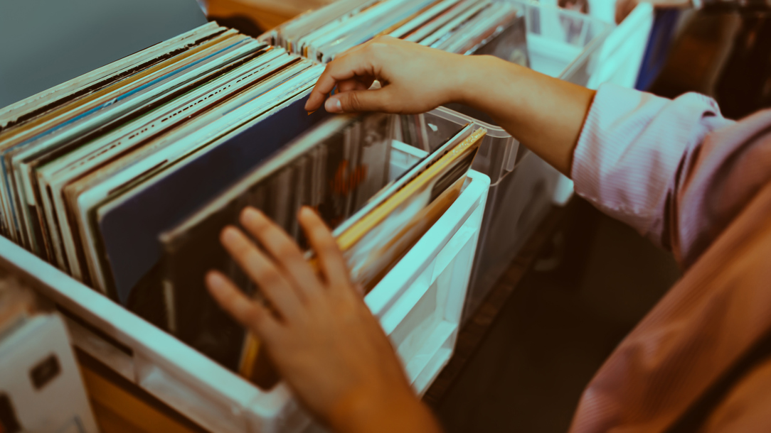 A person looking at Vinyl records.