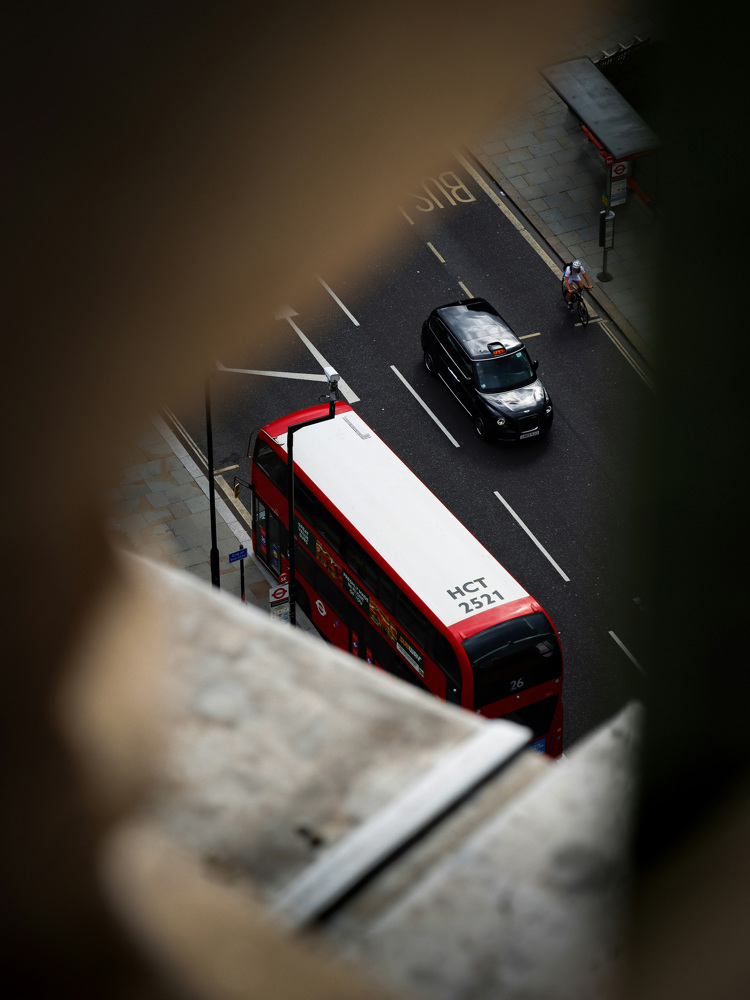 Looking down on a London cab and a bus.