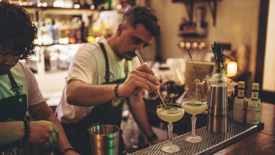 Two bar tenders making cocktails at the Tremeenda Muela bar.