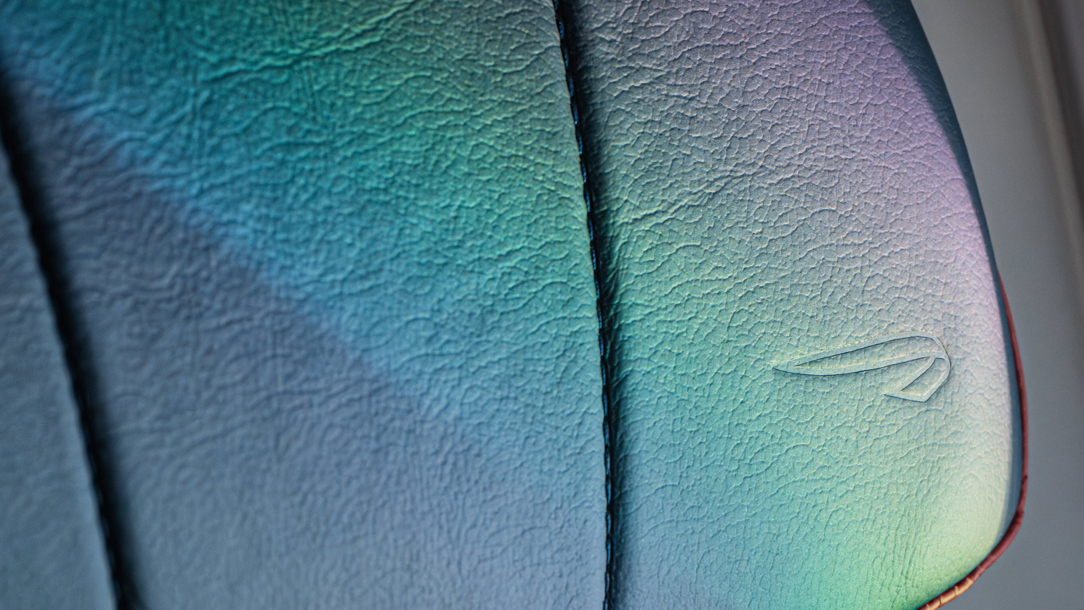 The British Airways speed mark symbol on a leather seat.