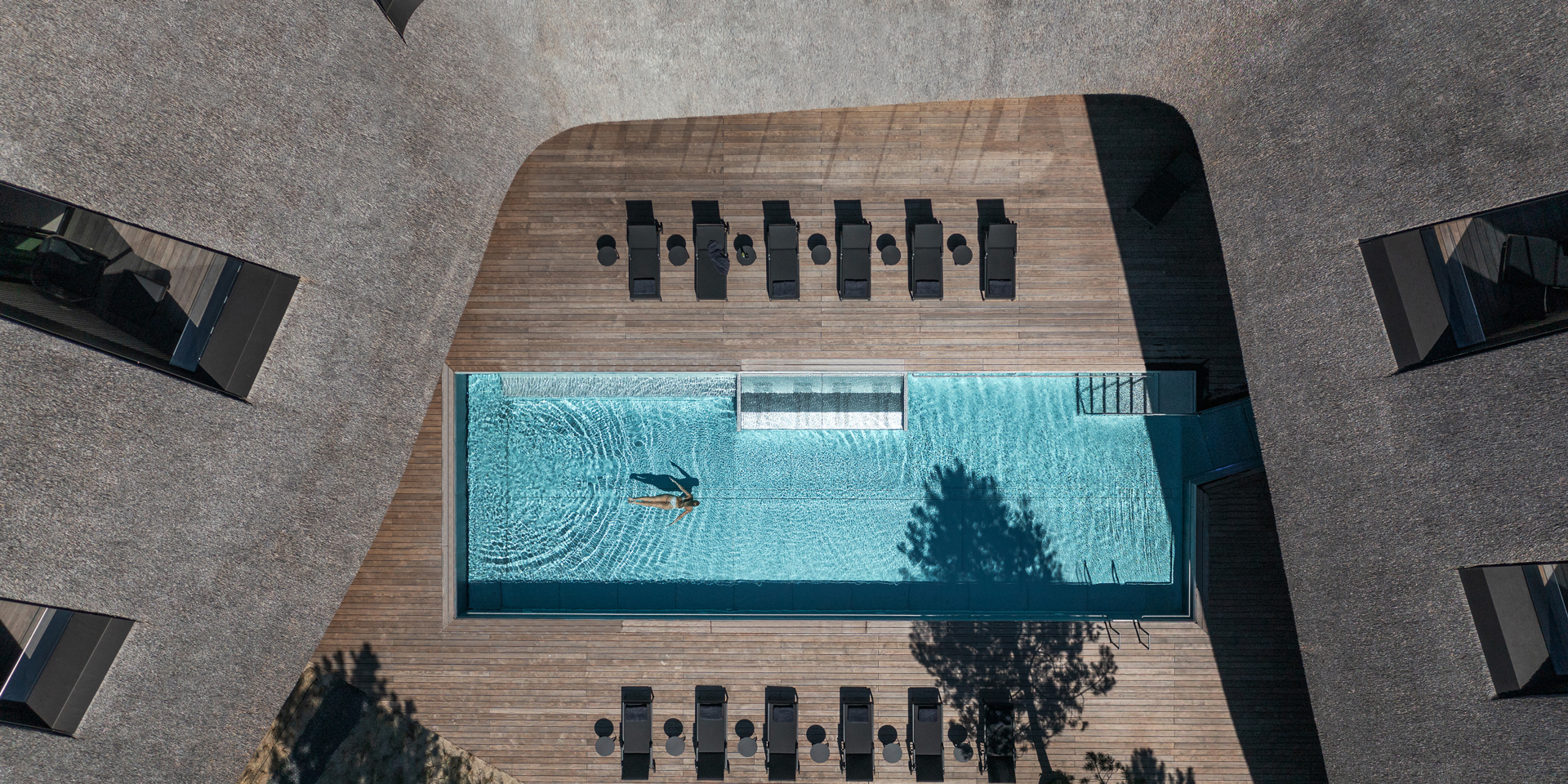 A woman in a swimming pool photographed from above.