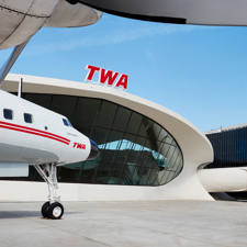 A small airplane parked outside the TWA Hotel.