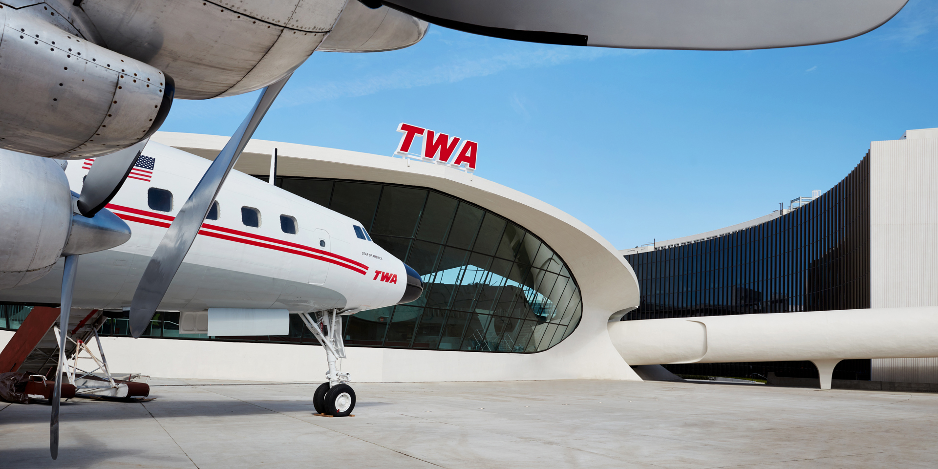 A small airplane parked outside the TWA Hotel.