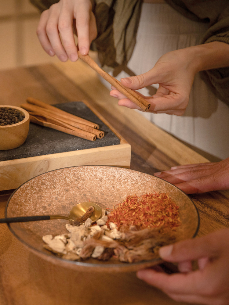 People holding herbs at the Anantara Layan resort.