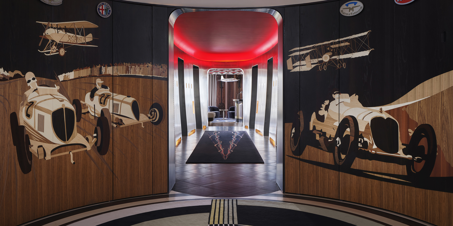 The lobby of Brooklands restaurant with elaborate marquetry depicting cars and planes.