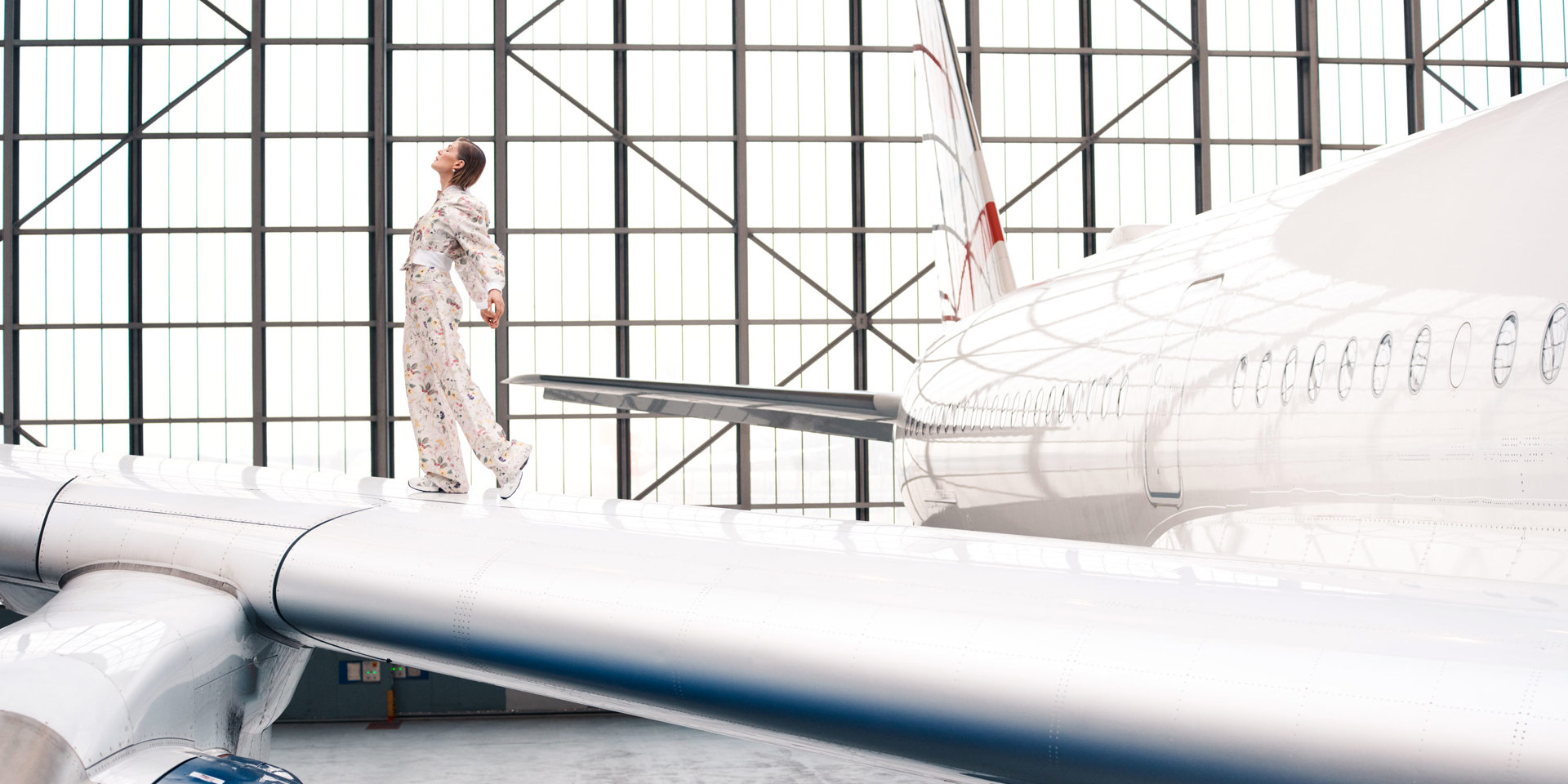 A portrait of Rosamund Pike on the wing of a British Airways plane.