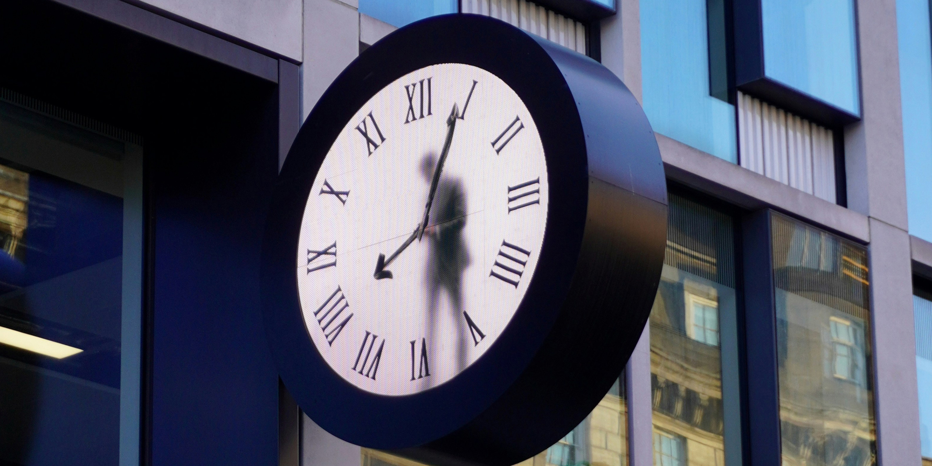 A clock with a figure on a person in the dial.