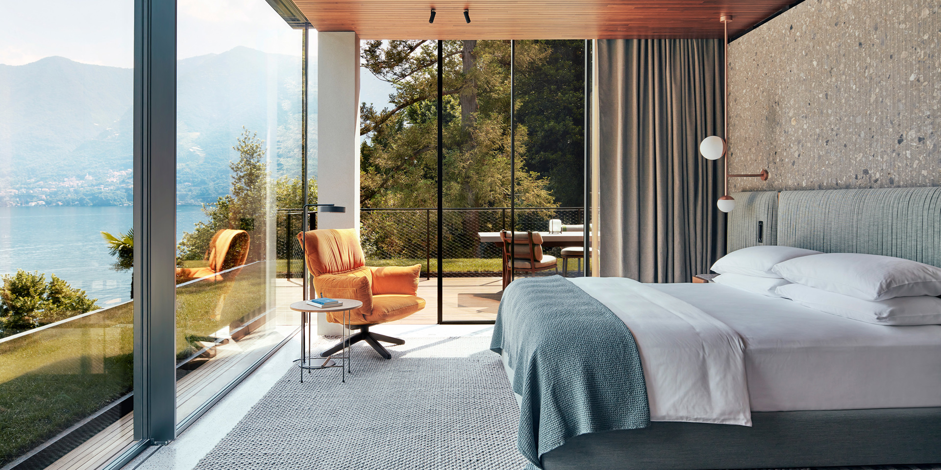 A bedroom with a glass wall at Il Sereno.