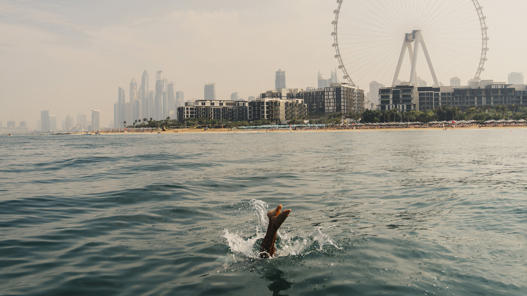 A person diving into the sea in Dubai.