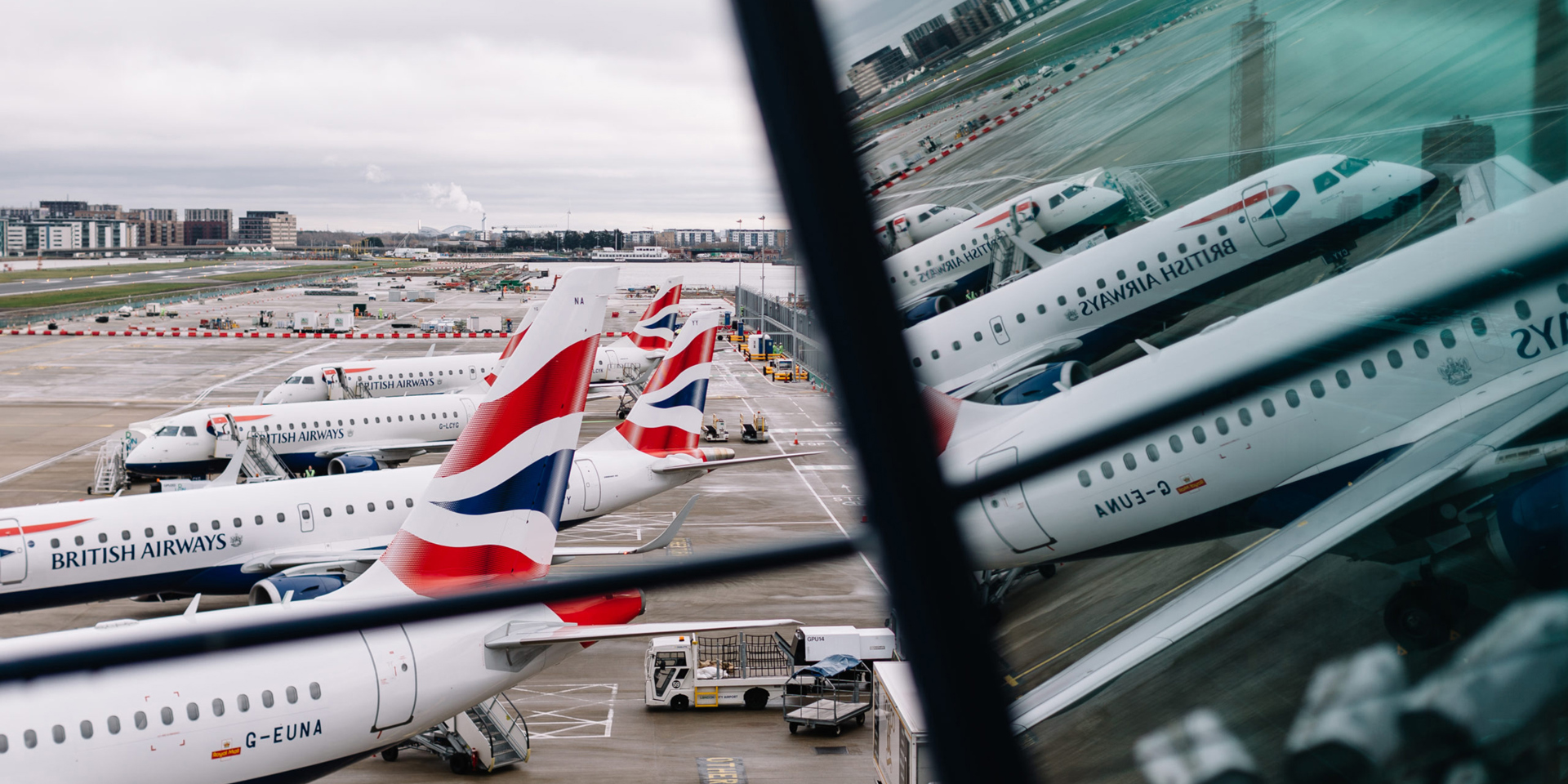 British Airways planes reflected in glass.