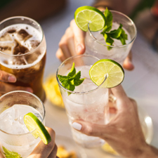 Friends toasting drinks in the summer.