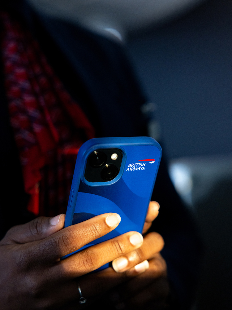 A British Airways colleague using a mobile phone.