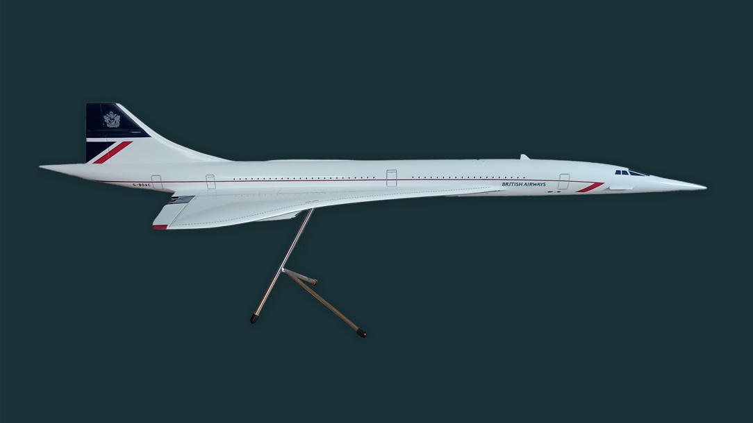 A model of Concorde on a dark green background.